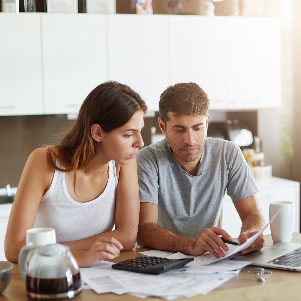 Young couple at home reviewing their family budget and long-term savings plan together