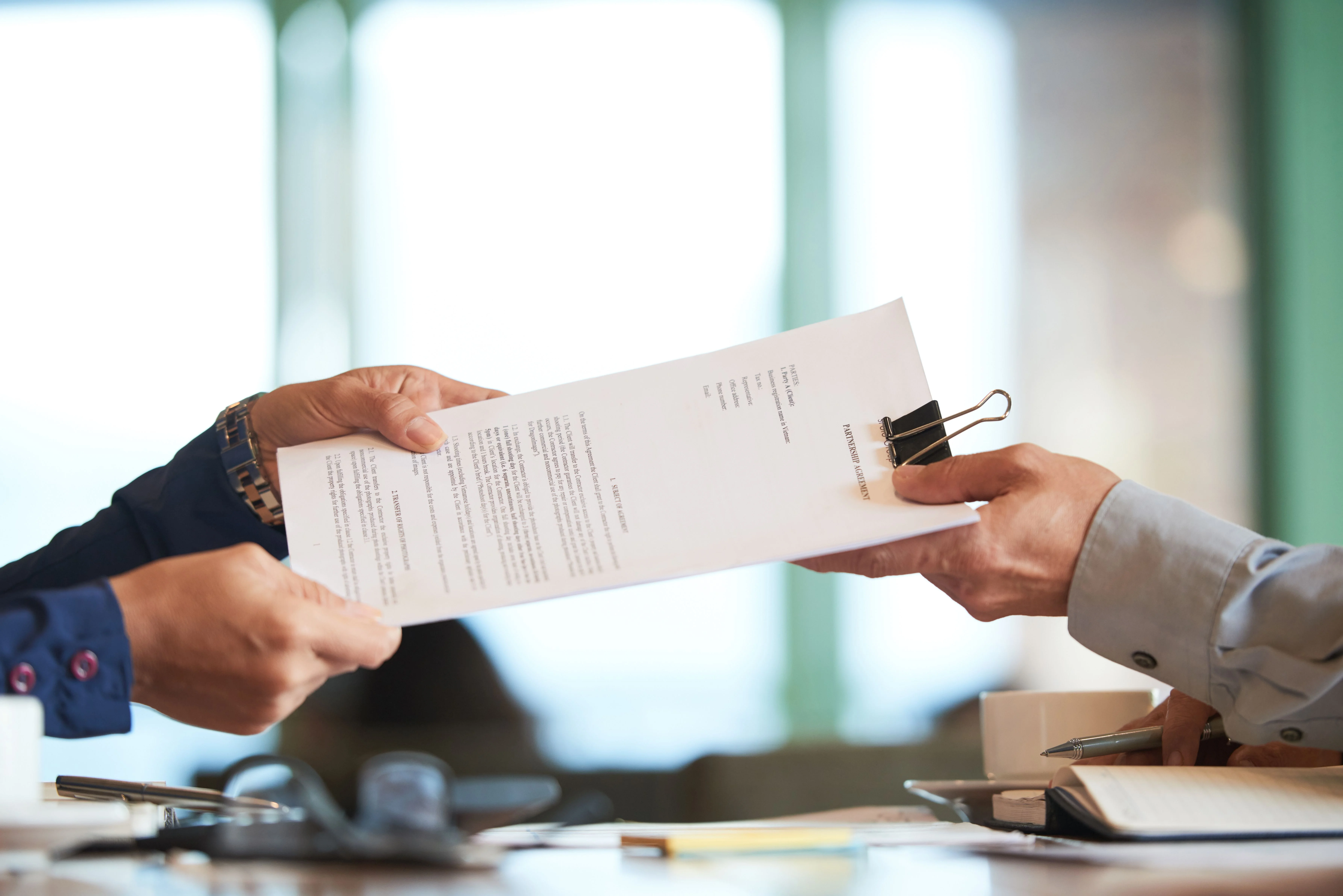 closeup-hands-passing-contract-unrecognizable-businessman.jpg